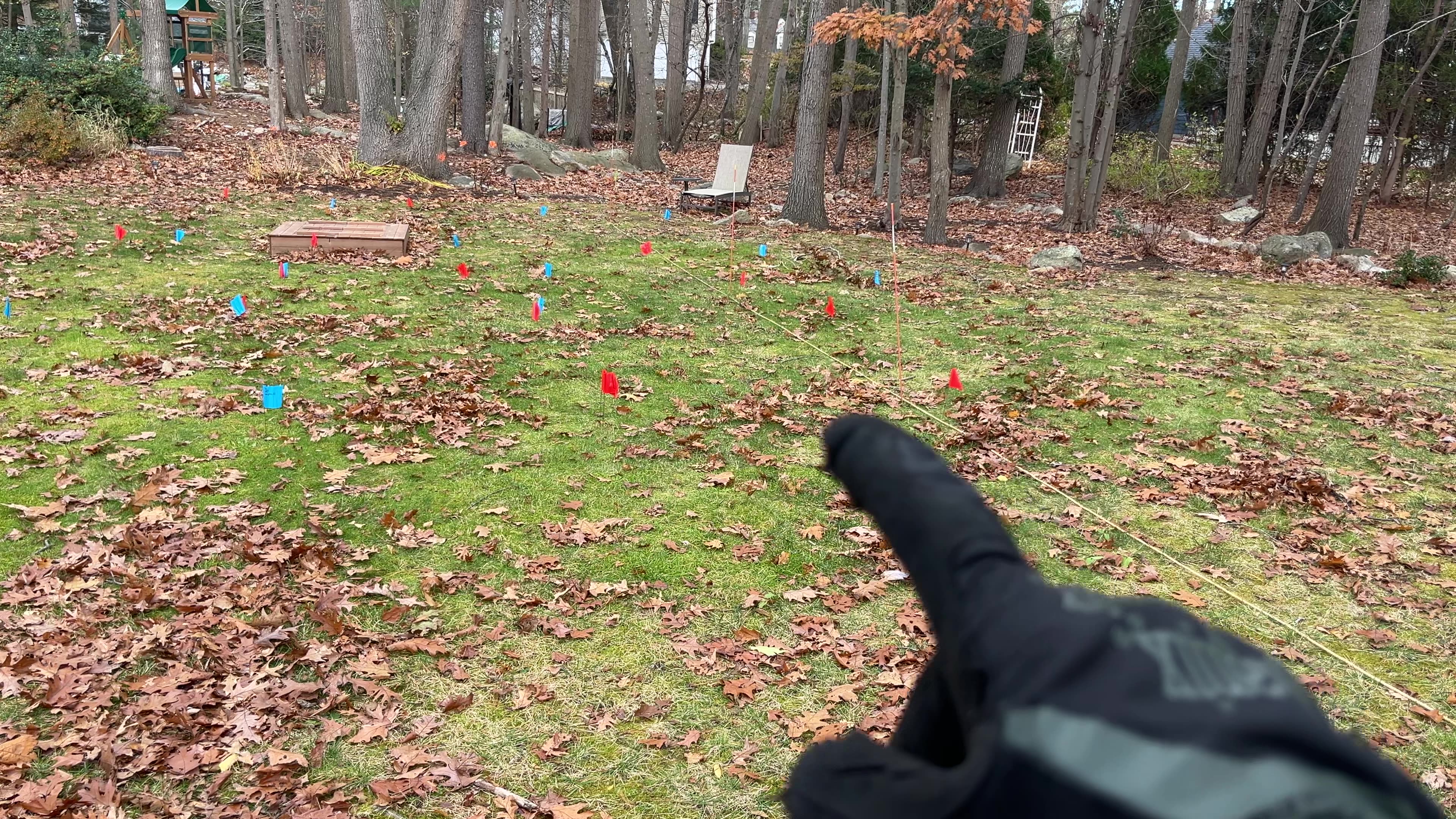 GPS fence boundary testing setup with red and blue flags marking correction points across the test area