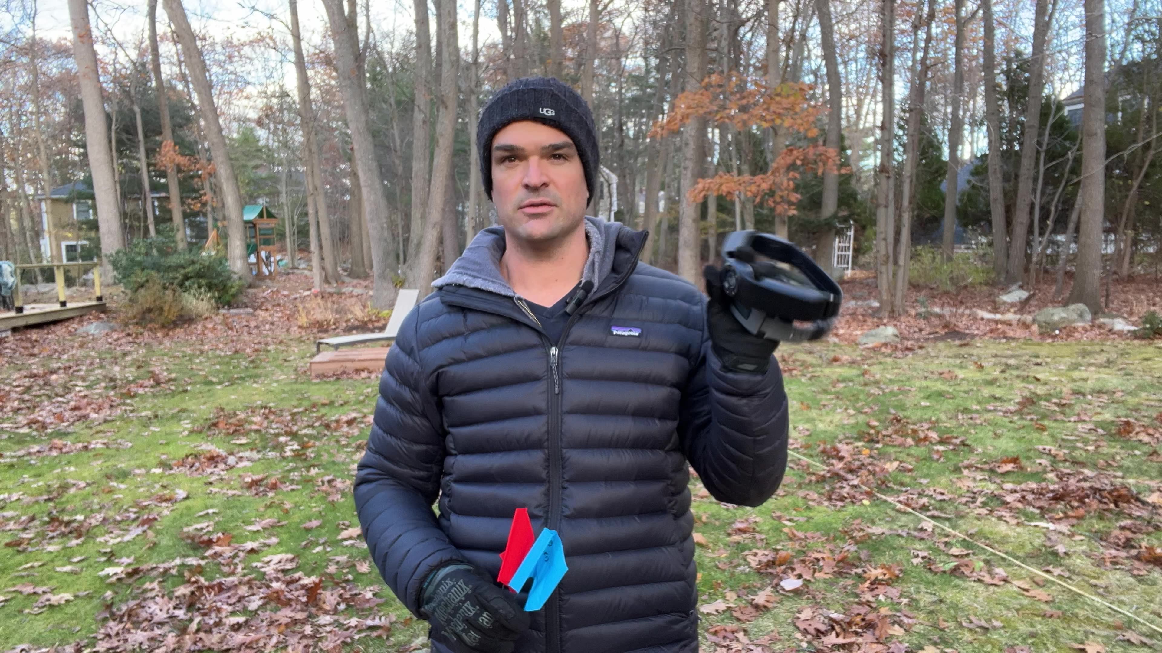 Our tester holding the SpotOn NOVA collar and boundary flags during hands-on GPS accuracy testing